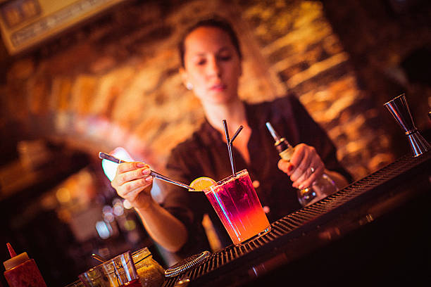 istock Midsection of young female bartender preparing cocktail in cocktail bar 530818516