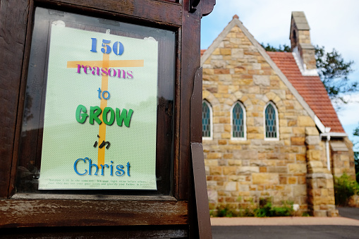 Sign outside a mellow old suburban church advertises \