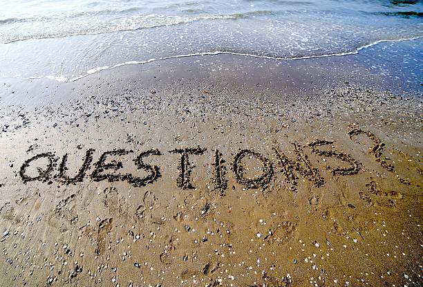 istock Questions with question mark written on the sand 530820092