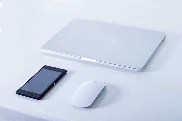 istock Open laptop with black smartphone 530825243