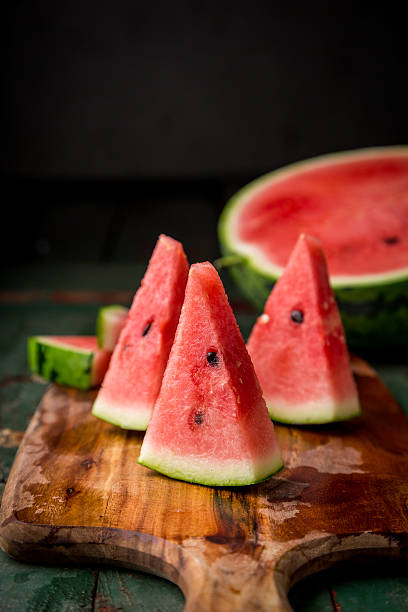 istock Watermelon sliced on wood background 530827268