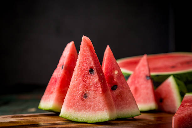 istock Watermelon sliced on wood background 530827390