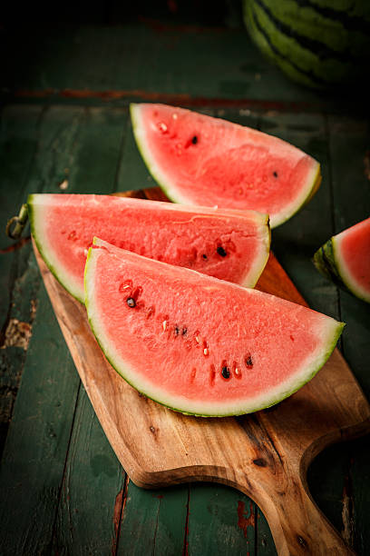 istock Watermelon sliced on wood background 530827498
