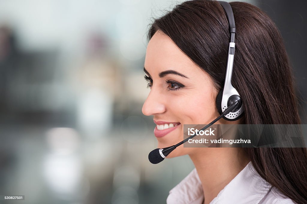 Call center Close-up, side view of attractive young woman is working in a call center.Attractive young woman is working in a call center. Adult Stock Photo