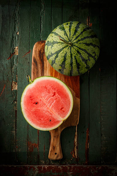Watermelon sliced on wood background stock photo