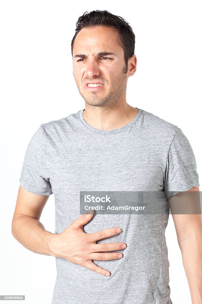 Man suffering from stomachache Mid-adult man in blue shirt having stomachache 30-39 Years Stock Photo