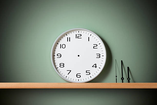 Stop time. Clock on the shelf. Blank clock face with hour, minute and second hands on the shelf. eternity stock pictures, royalty-free photos & images