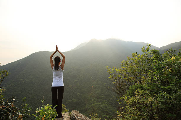 istock young woman practice yoga at mountain peak cliff 530830634