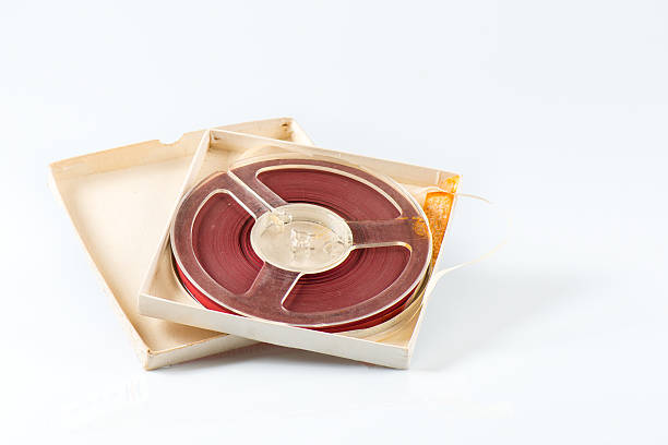 Open reel of quarter inch audio tape with case on white background