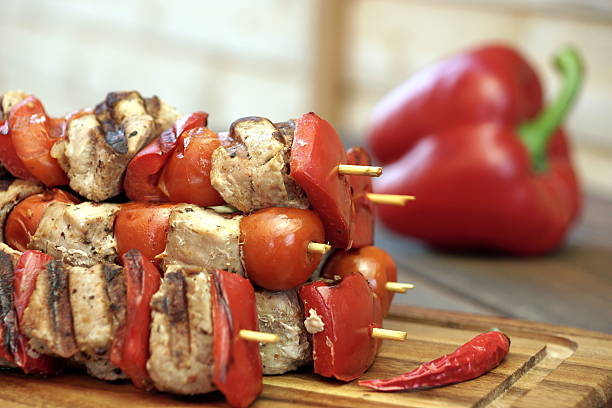 istock Stacked Skewered BBQ Shish Kebabs On The Wood Cutting Board 530832334