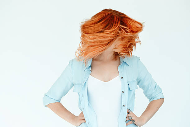 Motion Shot Of Dyed Hair Motion shot of woman's hair. Dyed hair in daylight concept. Beautiful woman with copyspace. dyed red hair photos stock pictures, royalty-free photos & images