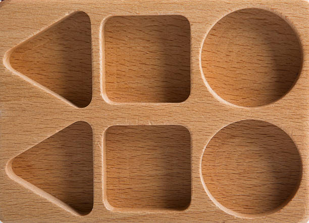 Baby sorter with geometric figures from wood on white isolated