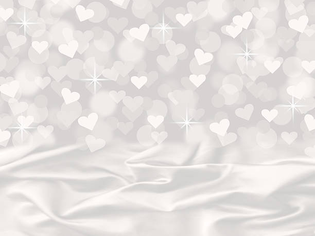 istock white satin heart bokeh valentine's day card background with sparkles 530840447