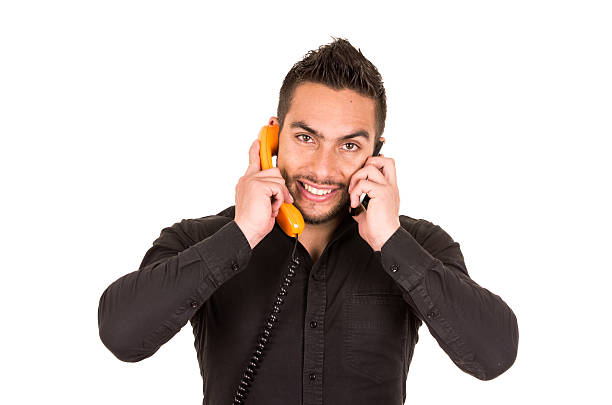istock closeup shot of handsome man using corded telephone and cell 530842187