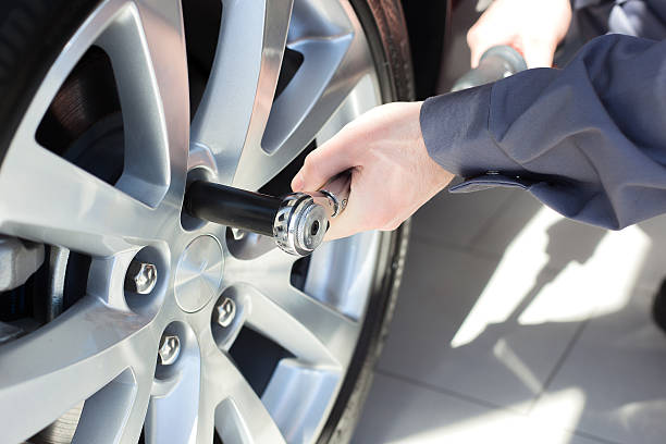 istock Mechanic changing wheel on car 530842777