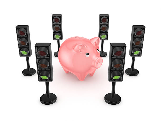 istock Traffic lights around pink piggy bank. 530845317