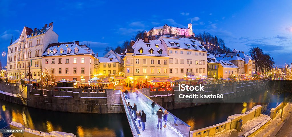 Ljubljana in Christmas time. Slovenia, Europe. Ljubljana in Christmas time. Lively nightlife in old medieval city center decorated with Christmas lights. Slovenia, Europe. Shot at dusk with fish eye lens. Architecture Stock Photo