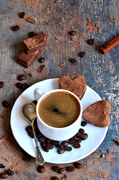istock Cup of coffee with heart-shaped chocolate truffles. 530851043