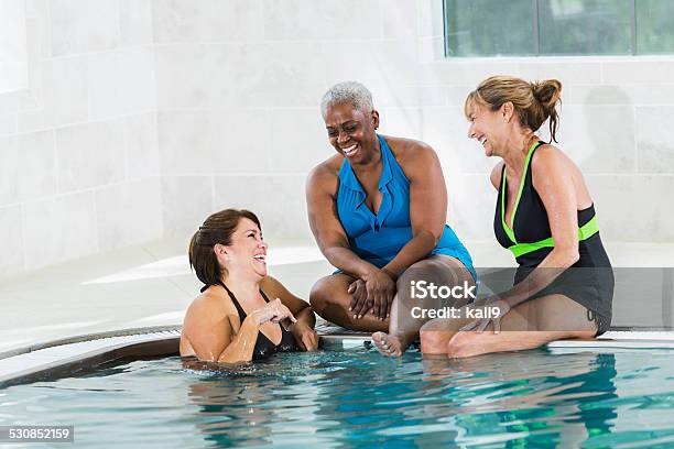 Group of women relaxing and talking in swimming pool