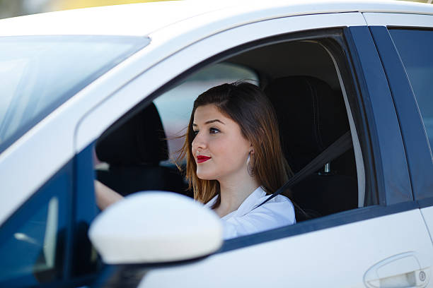 istock Young woman driving car 530852277