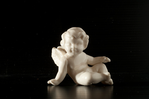 in the picture there is a cherub who may represent several symbols including, purity, baby, new, pure