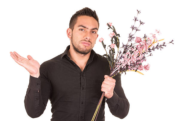 istock handsome young man holding a flower bouquet 530852769