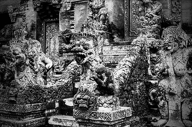 Ubud, Bali, Indonesia - December 4, 2012: Stone statues and stairs to the central shrine in the Hindu temple in the Mandala Wisata Wenara Wana monkey forest near Ubud in Bali.