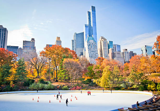 Ice rink Ice skaters having fun in New York Central Park in fall skate rink stock pictures, royalty-free photos & images