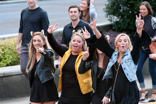 Atlanta, GA, USA - December 6, 2014:  Three female University of Missouri fans mug for the camera on their way to the Georgia Dome for the SEC Championship game against Alabama.