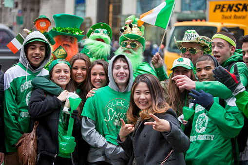 New York City, NY, USA - March 17, 2014: Participants and spectators at the annual St. Patrick's Day Parade that takes place on 5th Avenue in New York City. The parade is a celebration of Irish heritage in America and is the largest in the world.