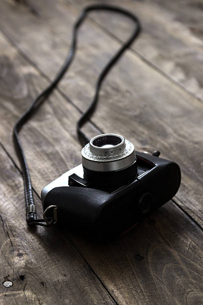 istock Vintage camera on wooden background 530863069