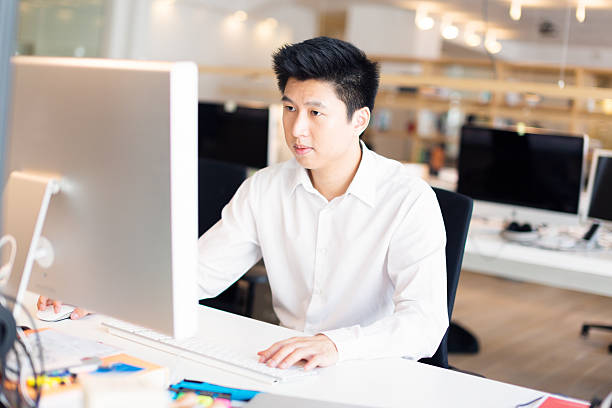 istock young asian office worker at his desk 530863911