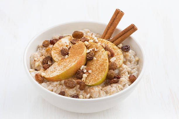 istock healthy breakfast - oatmeal with apples, raisins and cinnamon 530864479