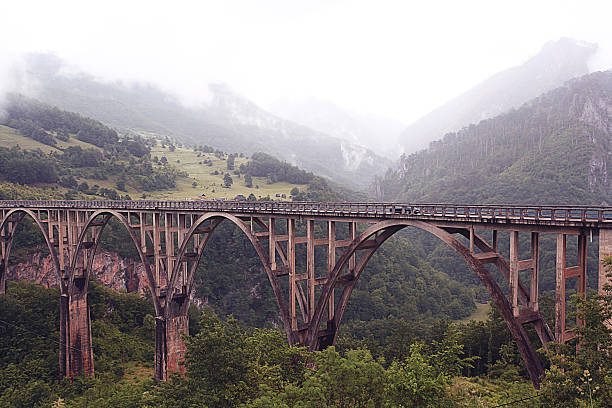 istock bridge in the mountains fog clouds rain 530864733