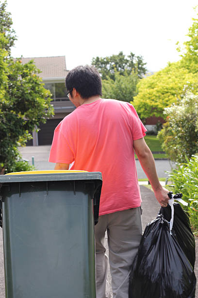 istock Young asian man taking out the garbabe bins 530865633