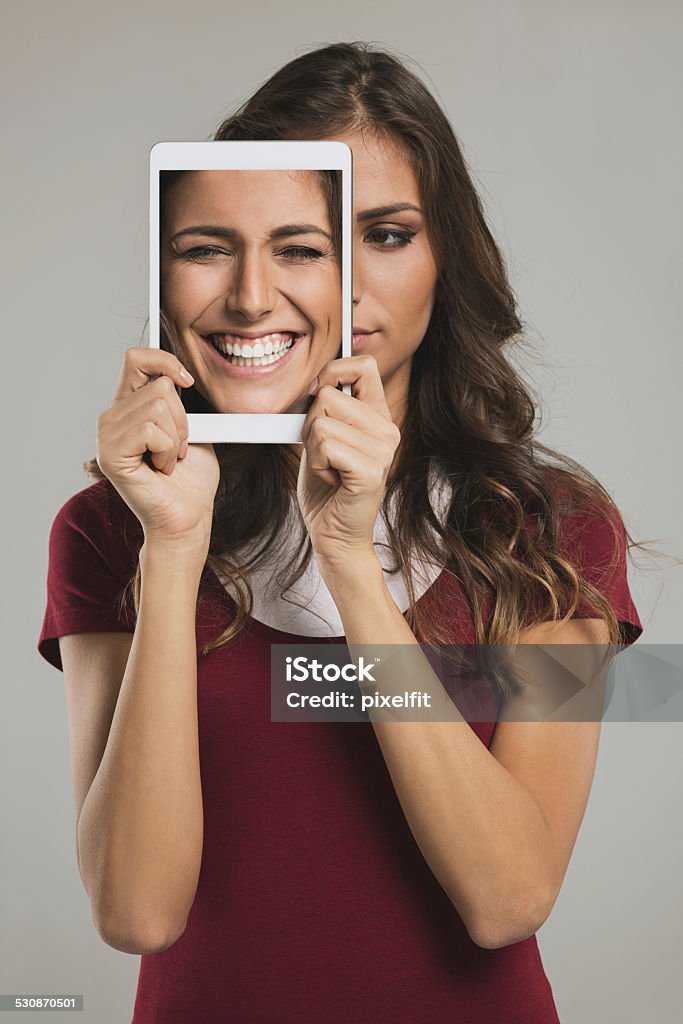Woman with digital tablet and different faces Studio shot Human Face Stock Photo