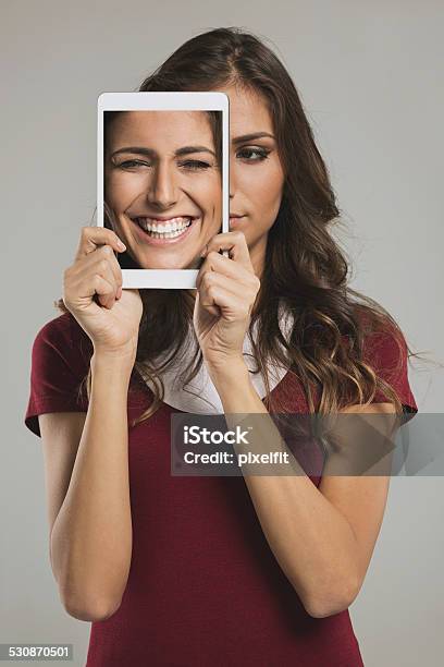 Woman With Digital Tablet And Different Faces Stock Photo - Download Image Now - Human Face, 2015, Adult