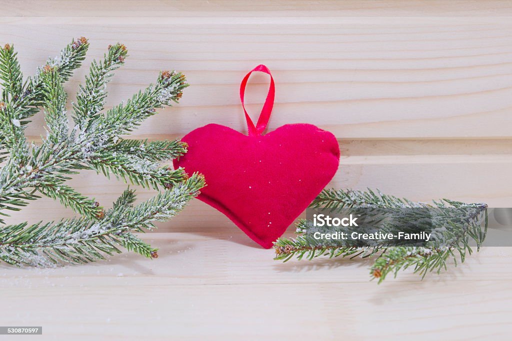 Heart and fir branches on a wooden surface Heart and fir branches covered with snow on a wooden surface Backgrounds Stock Photo