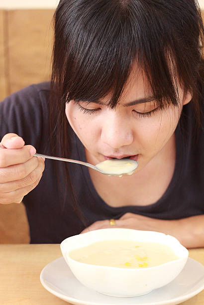 istock Asian young woman having corn soup 530871699