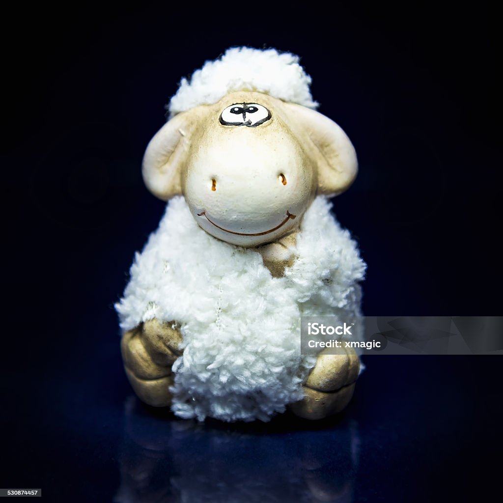 Sheep the symbol 2015 year White sheep toy the Chinese symbol of 2015 year on black and blue background with reflection 2015 Stock Photo
