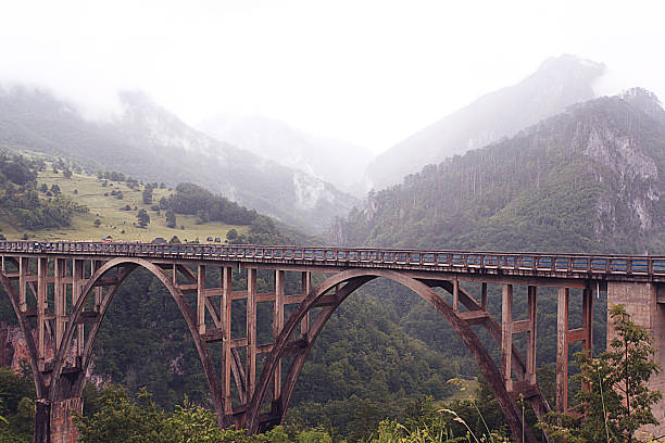 istock bridge in the mountains fog clouds rain 530874779