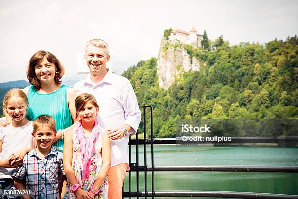 Family Posing For A Groupshot In Front Of Lake Bled Stock Photo - Download Image Now