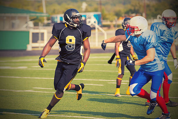 istock Football player running down field during professional game 530877493