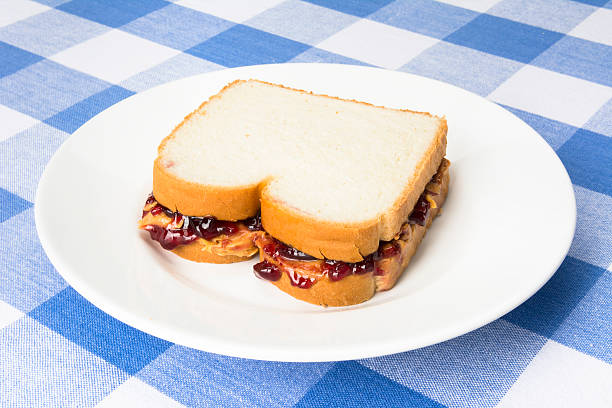 A delicious peanut butter and jelly sandwich with grape jam ready to be eaten during lunchtime.
