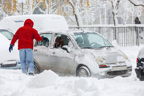 istock Man scraping frozen snow from car windows 530878167