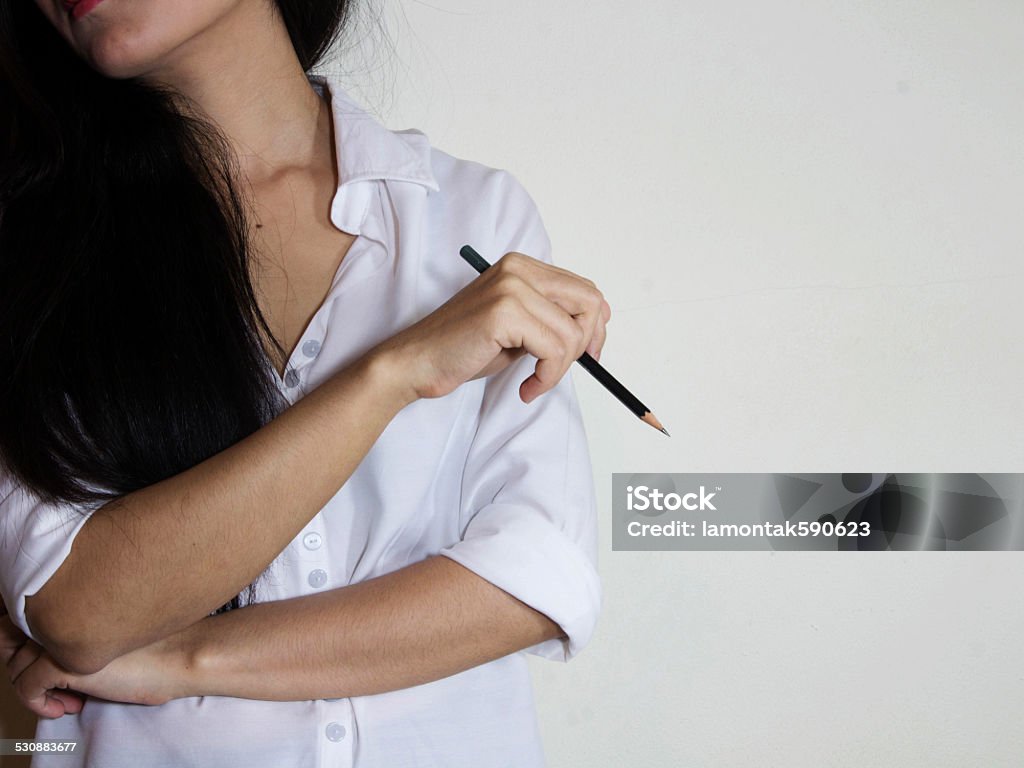 Portrait of businesswoman holding the pencel in room low light Adult Stock Photo