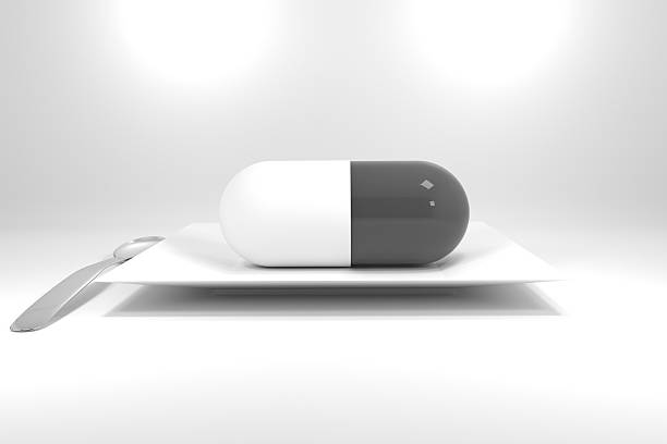 istock large grey pill on white plate and silver spoon 530885147