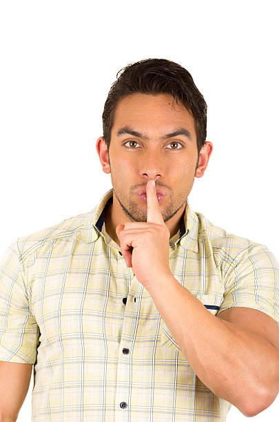 istock young handsome hispanic man gesturing a secret 530886961