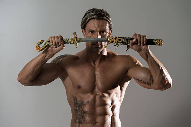 istock Mature Man Holding Sword Ready To Fight 530887429