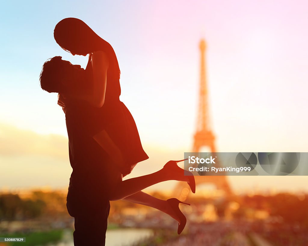 Romantic lovers with eiffel tower silhouette of romantic lovers with eiffel tower in Paris with sunset Paris - France Stock Photo